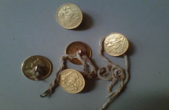 Description: Gold coat buttons used by M P Thomas Silva